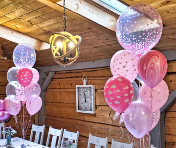 Bukiety balonów z helem jako urodzinowa dekoracja stołów.